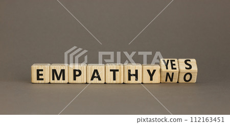 Empathy yes or no symbol. Concept words Empathy no to Empathy yes on beautiful wooden cubes. Beautiful grey table grey background. Psychological and empathy yes or no concept, copy space. 112163451