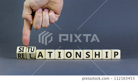 Relationship or situationship symbol. Concept word Relationship situationship on wooden cubes. Beautiful grey background. Businessman hand. Business relationship situationship concept. Copy space. 112163453