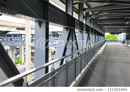 Pedestrian pathway or corridor or hallway between train station and other building. Pedestrian pathway or corridor or hallway between train station and other building. 112163464