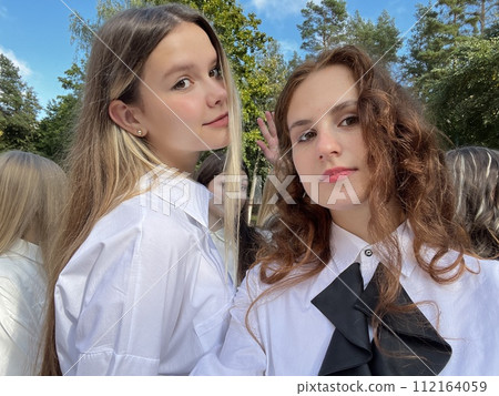 School children taking a photo on a summer day. 112164059