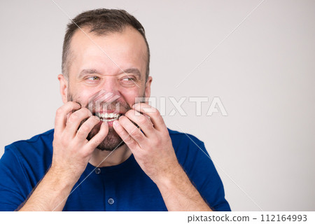 Man biting his nails 112164993