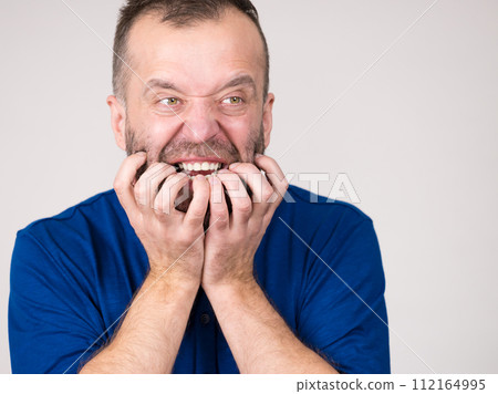 Man biting his nails 112164995