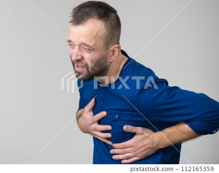 Man having heart pain attack 112165359