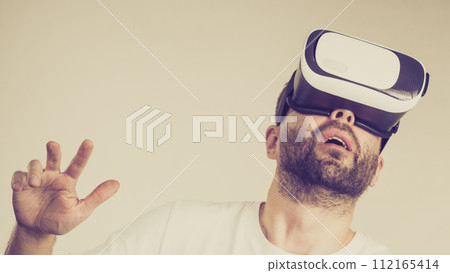 Adult man wearing vr goggles 112165414