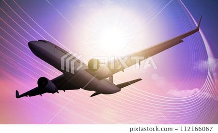 airplane flying against the sun 112166067