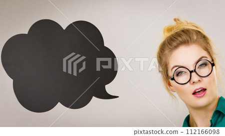 Woman holding black thinking bubble 112166098