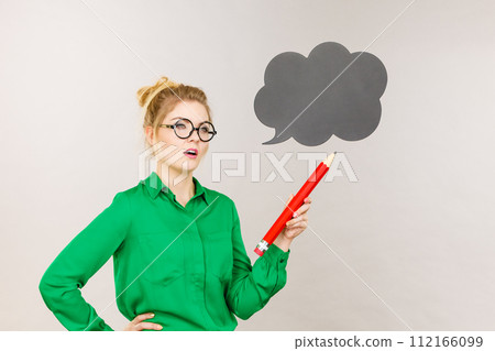 Woman holding big oversized pencil thinking 112166099