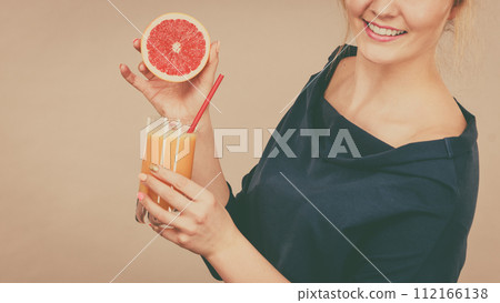 Happy woman holding fresh orange juice Happy woman holding fresh orange juice 112166138