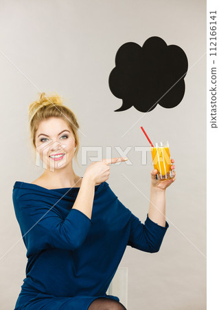 Happy woman holding fresh orange juice 112166141