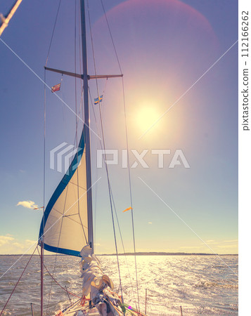 Yachting on sail boat during sunny weather Yachting on sail boat during sunny weather 112166262