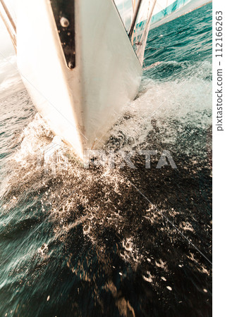 Yachting on sail boat bow stern shot splashing water 112166263