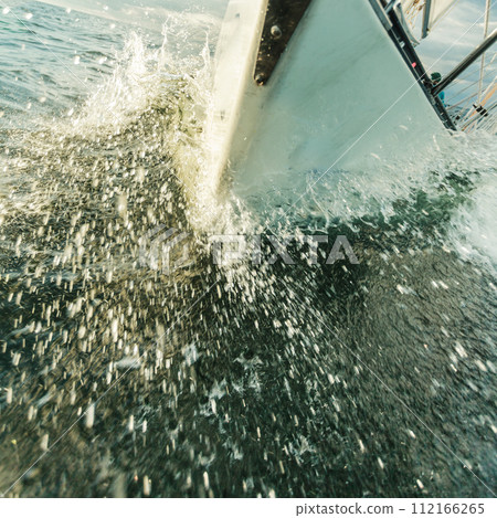 Yachting on sail boat bow stern shot splashing water Yachting on sail boat bow stern shot splashing water 112166265