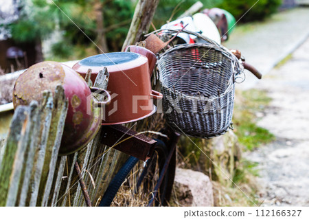 Old wooden fence with pots on it 112166327