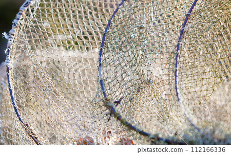 Fishing equipment. Closeup of white fishnet net outdoor 112166336