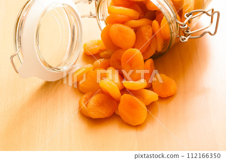 Diet. Glass jar of apricots dried fruits. 112166350