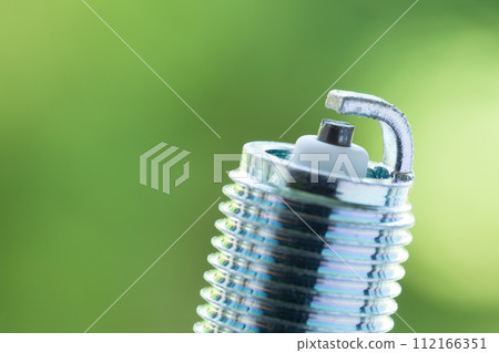 Auto service. New spark plug as spare part of car. 112166351