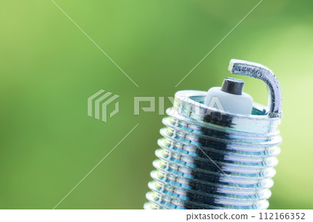 Auto service. New spark plug as spare part of car. Auto service. New spark plug as spare part of car. 112166352