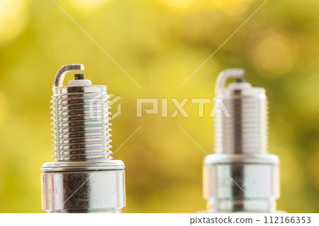 Auto service. Two new spark plugs as spare part of car. Auto service. Two new spark plugs as spare part of car. 112166353