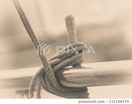 Rope tied around hook on handrail 112166374
