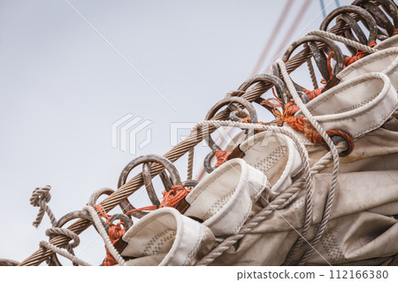 Detailed closeup of mast rigging on sail boat Detailed closeup of mast rigging on sail boat 112166380