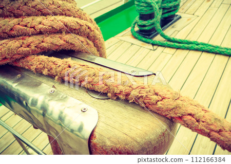 Old fashioned harbor marina sailboat ropes Old fashioned harbor marina sailboat ropes 112166384