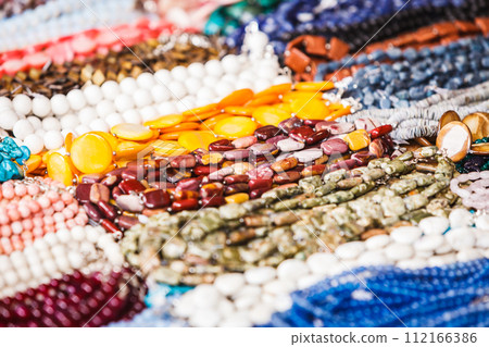 Many decorative necklaces made of colorful stones Many decorative necklaces made of colorful stones 112166386