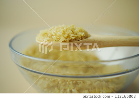 Raw Bulgur Rice on wooden spoon , 112166808