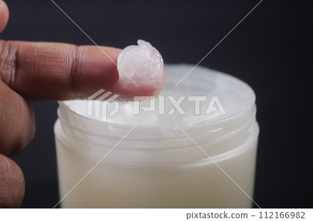 Close up of man hand using petroleum jelly 112166982