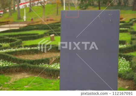 A black ceramic billboard stands in the park 112167091