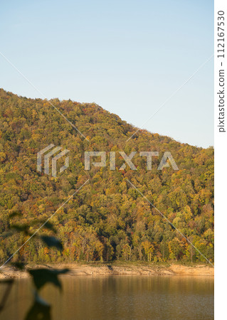 Dam lake of Chubetsu Dam and mountains with autumn leaves in Daisetsuzan National Park in Higashikawa Town, Hokkaido Dam lake of Chubetsu Dam and mountains with autumn leaves in Daisetsuzan National Park in Higashikawa Town, Hokkaido 112167530