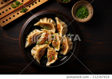 Grilled dumplings meat gyoza in black plate with soy sauce 112167818