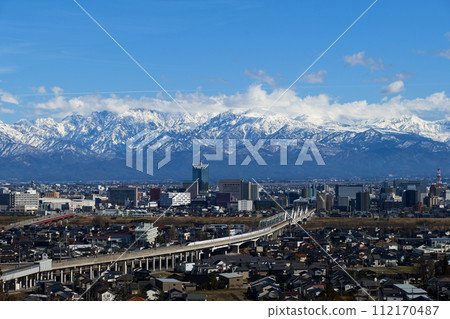 The Tateyama Mountain Range of the Northern Alps seen from Mt. Kureha and the downbound Shinkansen departing from Toyama City Station The Tateyama Mountain Range of the Northern Alps seen from Mt. Kureha and the downbound Shinkansen departing from Toyama City Station 112170487