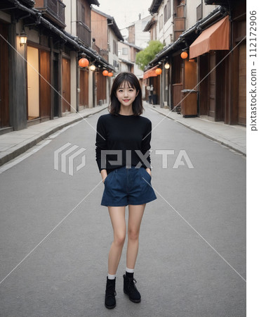 年輕女子穿過一條兩旁都是日本老房子的街道 112172906