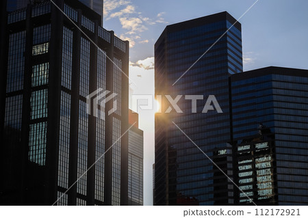 Skyscraper glass facades on a bright sunny day with sunbeams Jan 13 2024 112172921