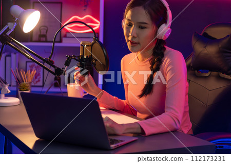 Smiling creative young beautiful Asian influencer talking in channel. Stratagem. Smiling creative young beautiful Asian influencer talking in channel. Stratagem. 112173231