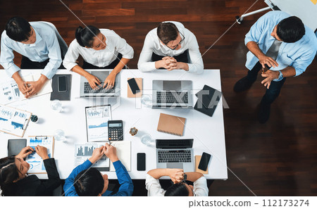 Analyst team utilizing BI Fintech to analyze financial data at table. Prudent 112173274