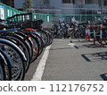 Bicycles lined up in the bicycle parking lot 112176752