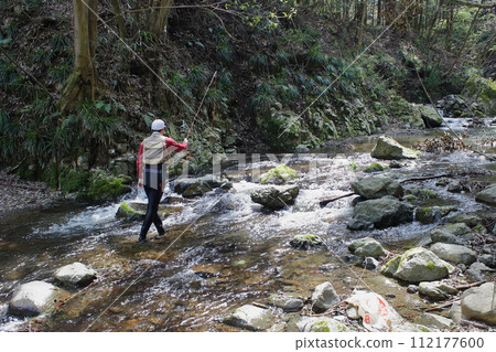 Anglers enjoying fly fishing in a nearby mountain stream 112177600