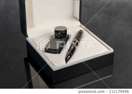 Fountain pen on marble and gray background with reflection. Vibration focus. Fountain pen on marble and gray background with reflection. Vibration focus. 112179406