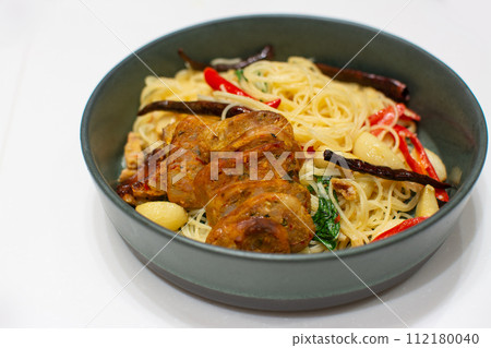 Spaghetti with Northern Thai spicy sausage on white background. 112180040