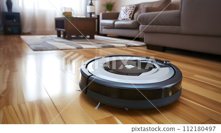close up of a robotic vacuum glides seamlessly across a polished hardwood floor 112180497