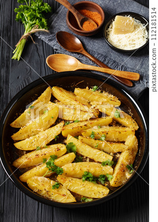 greek lemon potatoes with garlic, cheese on dish 112181514
