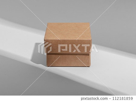 Kraft carton box of square shape, small little cardboard package Kraft carton box of square shape, small little cardboard package 112181859