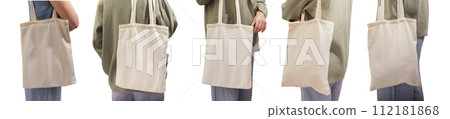 Natural fabric eco tote bag mockup in hand. Woman with shopper, totebag isolated on white Natural fabric eco tote bag mockup in hand. Woman with shopper, totebag isolated on white 112181868