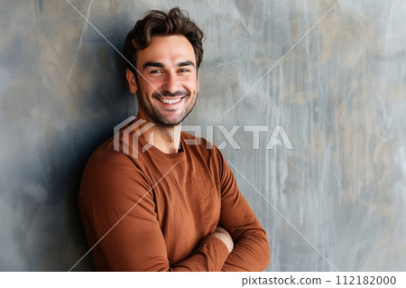 Young man with beard posing in a brown sweater 112182000