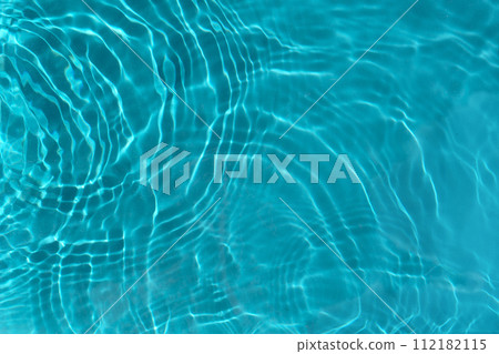 Transparent turquoise clear water surface texture with ripples, waves and rings in sunlight. 112182115