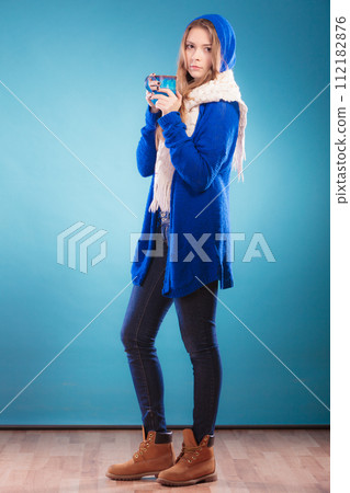 teen girl holding blue mug with hot drink teen girl holding blue mug with hot drink 112182876