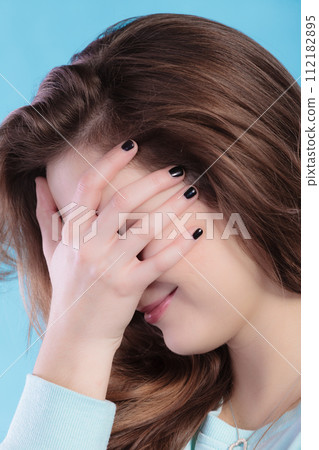 teenage girl cover the face with hand. teenage girl cover the face with hand. 112182895