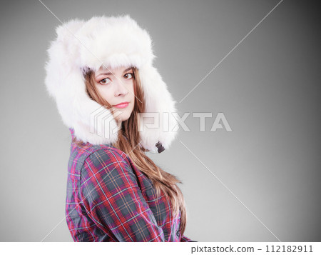 Young woman in winter clothing fur cap 112182911