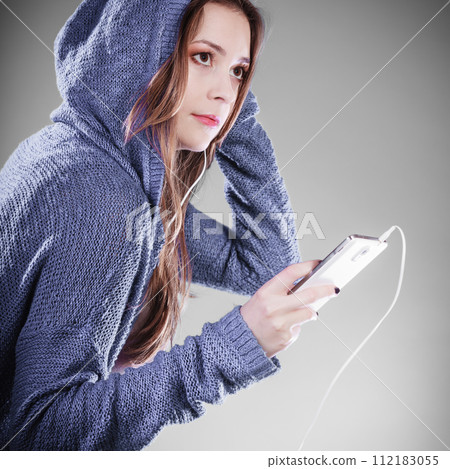 young woman with smart phone listening music 112183055